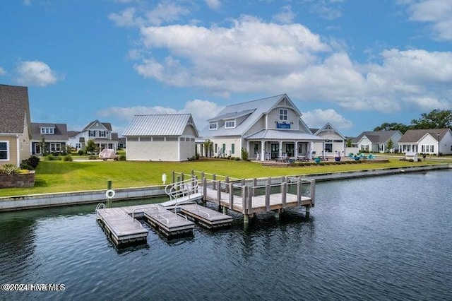 dock area featuring a lawn, a water view, and a residential view