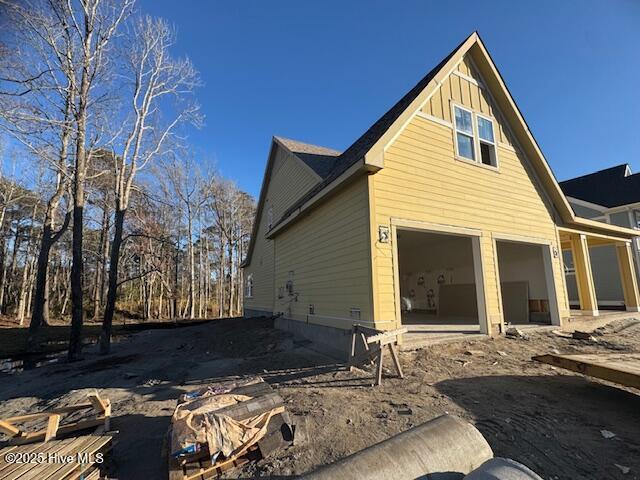 view of side of home featuring a garage