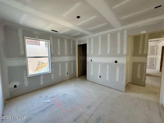 unfurnished room with visible vents