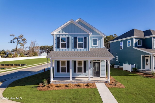 view of front facade with a front yard and a porch