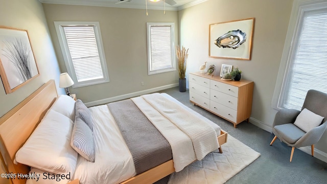 carpeted bedroom with ornamental molding and multiple windows