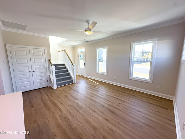 interior space featuring ceiling fan, wood-type flooring, and ornamental molding