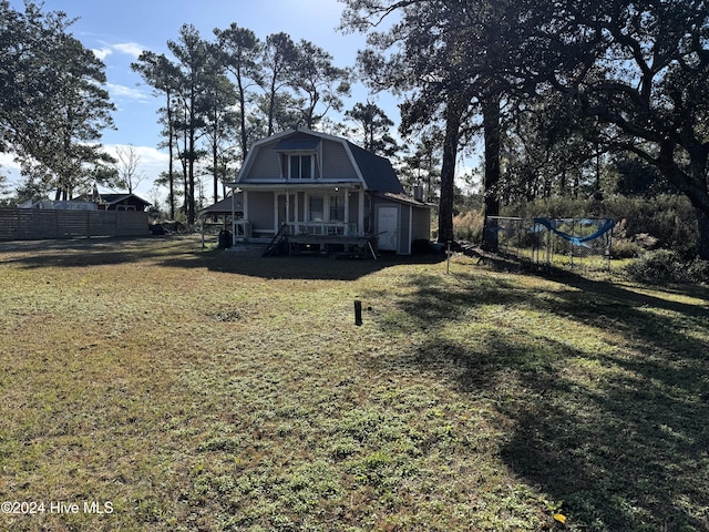 back of property featuring a yard and a porch