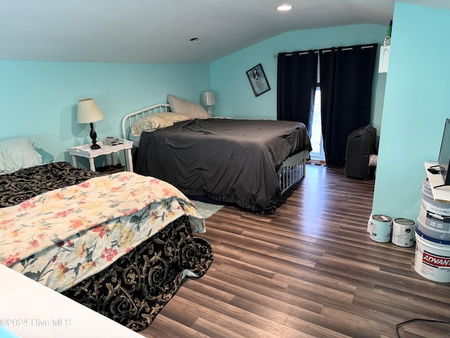 bedroom featuring dark hardwood / wood-style flooring and vaulted ceiling