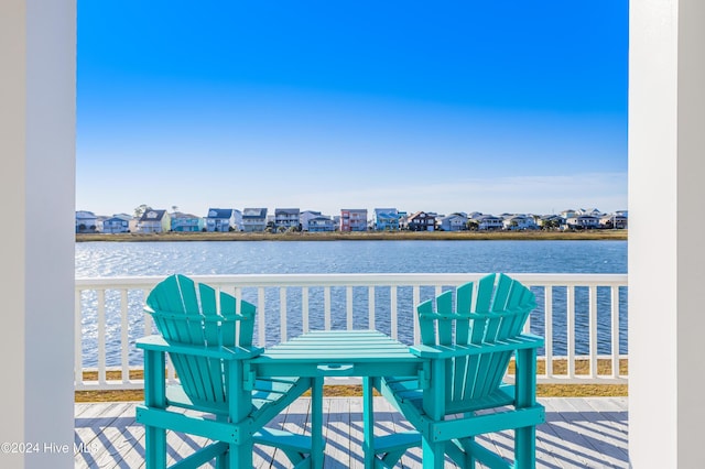 balcony featuring a residential view and a water view