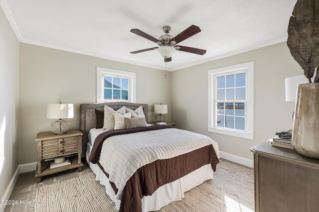bedroom featuring ceiling fan, baseboards, and ornamental molding