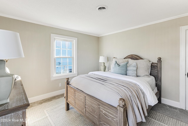 carpeted bedroom with baseboards, ornamental molding, and visible vents
