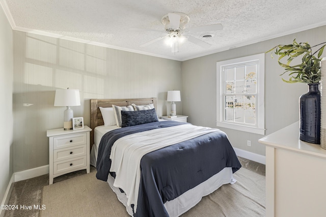 bedroom with visible vents, ornamental molding, light carpet, a textured ceiling, and baseboards