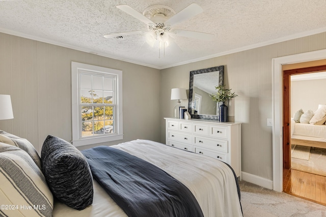 bedroom with light carpet, visible vents, ornamental molding, and ceiling fan