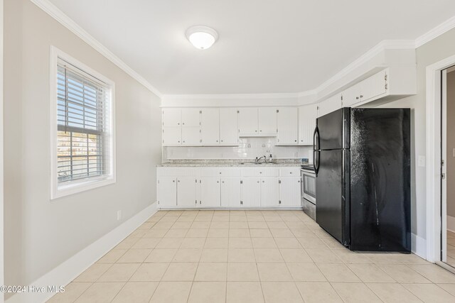 kitchen with electric stove, ornamental molding, freestanding refrigerator, white cabinets, and light tile patterned flooring