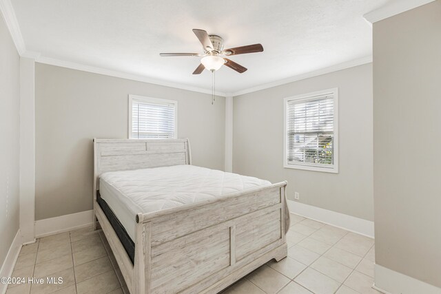 bathroom with crown molding, tile patterned flooring, and vanity