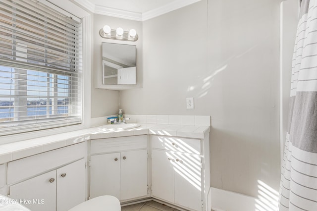 full bath with tile patterned floors, ornamental molding, and vanity