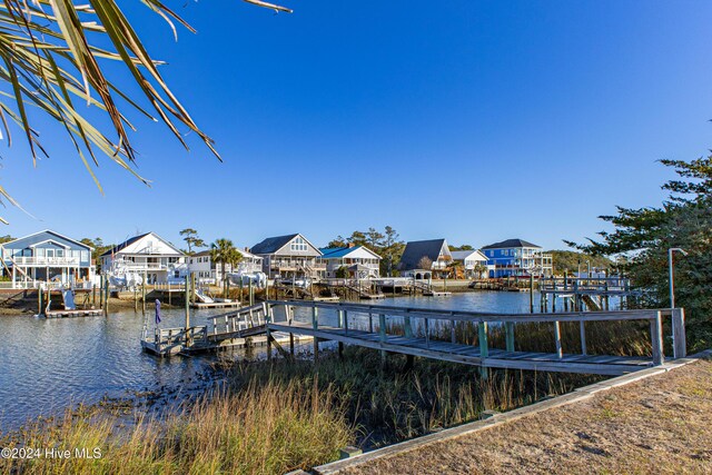 view of dock with a water view and a residential view