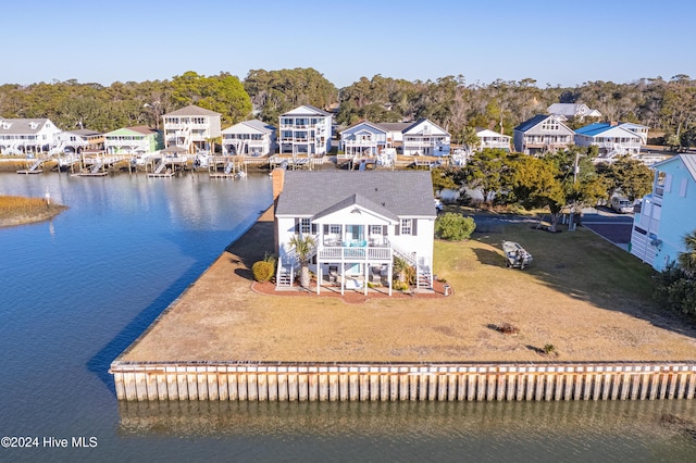 birds eye view of property with a residential view and a water view