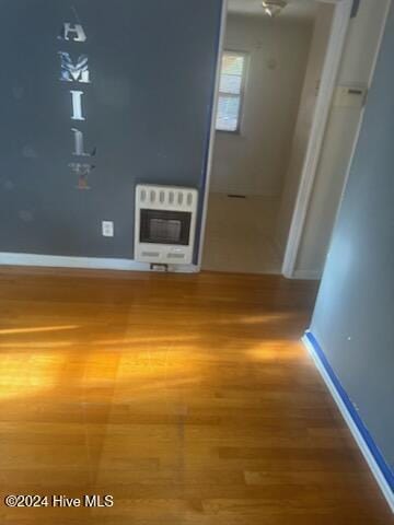 interior space with heating unit and hardwood / wood-style floors