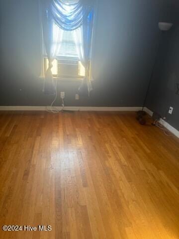 unfurnished room with hardwood / wood-style floors