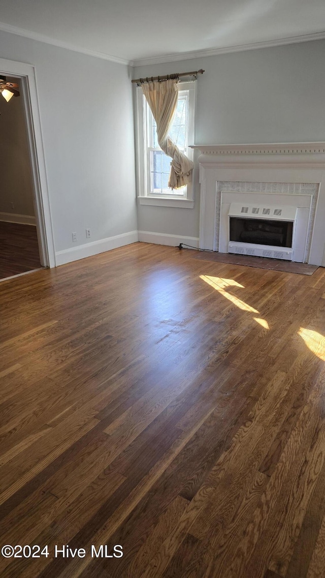 unfurnished living room with heating unit, dark hardwood / wood-style flooring, and ornamental molding