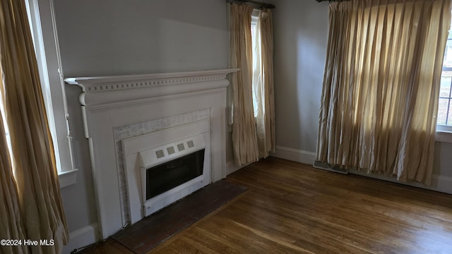 unfurnished living room featuring dark wood-type flooring and heating unit