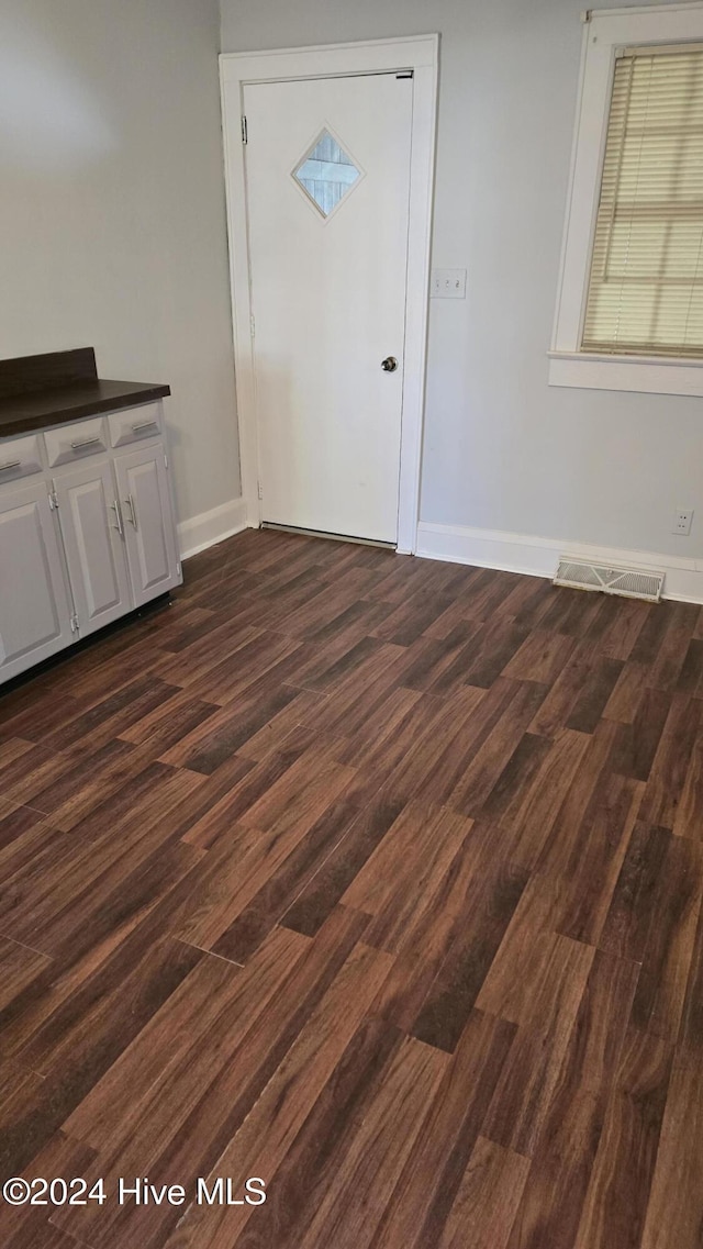 unfurnished dining area with dark hardwood / wood-style floors