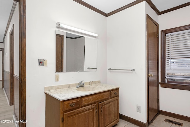 bathroom with vanity, crown molding, and tile patterned floors