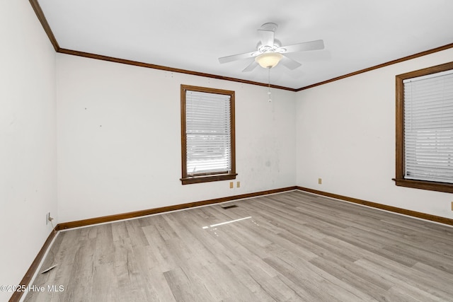 spare room with ceiling fan, light hardwood / wood-style floors, and crown molding