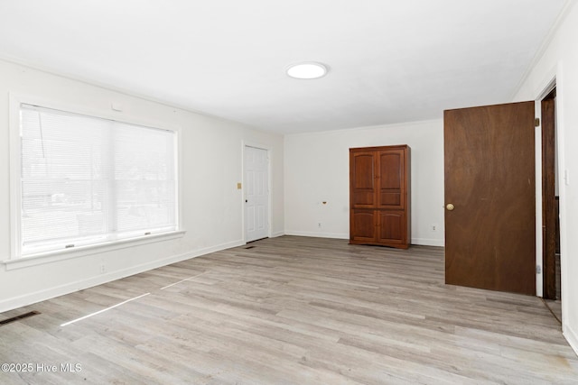 unfurnished room with light hardwood / wood-style flooring