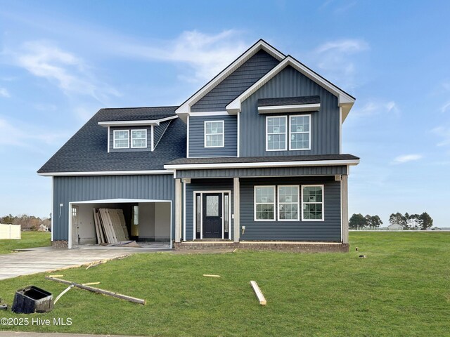 view of front of property featuring a garage and a front lawn