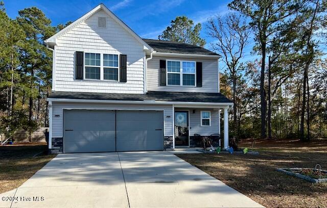 49 Patrick Henry Cir NW, Supply, NC 28462 - view of front facade with an attached garage, driveway, and covered porch