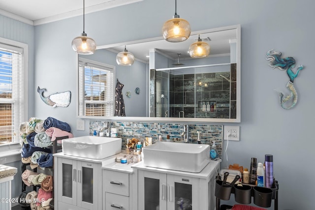 bathroom featuring backsplash, crown molding, vanity, and a shower with shower door