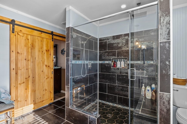 bathroom featuring tile patterned floors, toilet, an enclosed shower, and ornamental molding