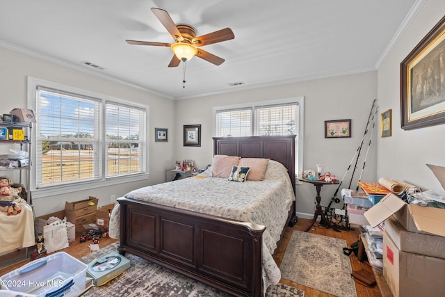 bedroom with ceiling fan, ornamental molding, and hardwood / wood-style flooring