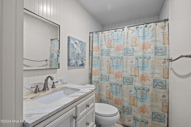 bathroom with vanity, curtained shower, and toilet