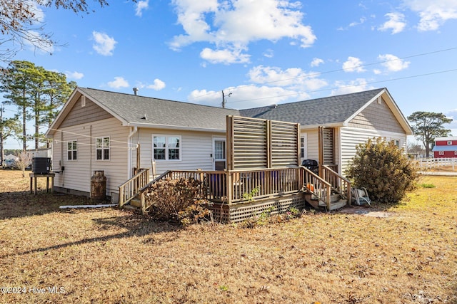 rear view of property featuring central AC unit and a deck