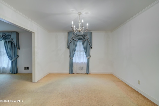 unfurnished room with crown molding, carpet floors, and an inviting chandelier