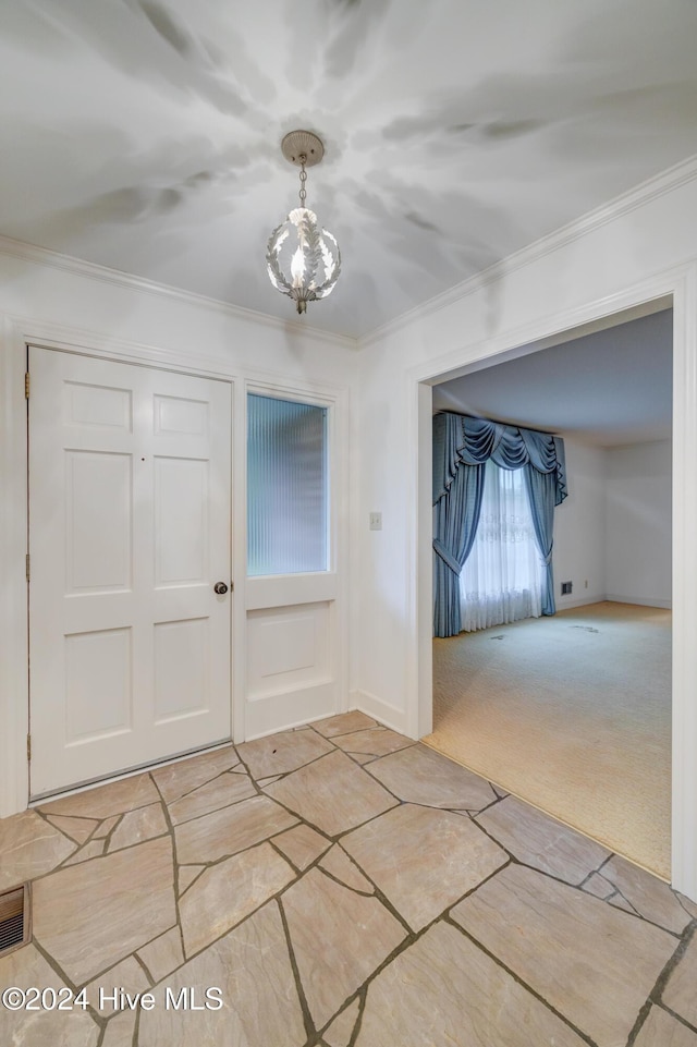 carpeted entryway featuring crown molding