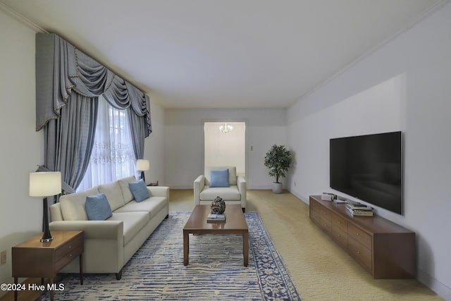 carpeted living room with ornamental molding and an inviting chandelier