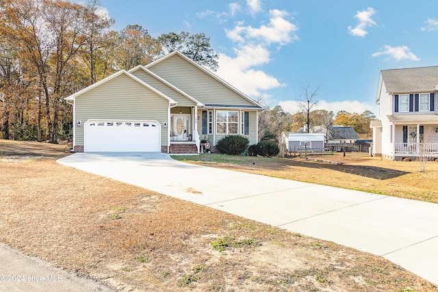 view of front of house featuring a front lawn and a garage