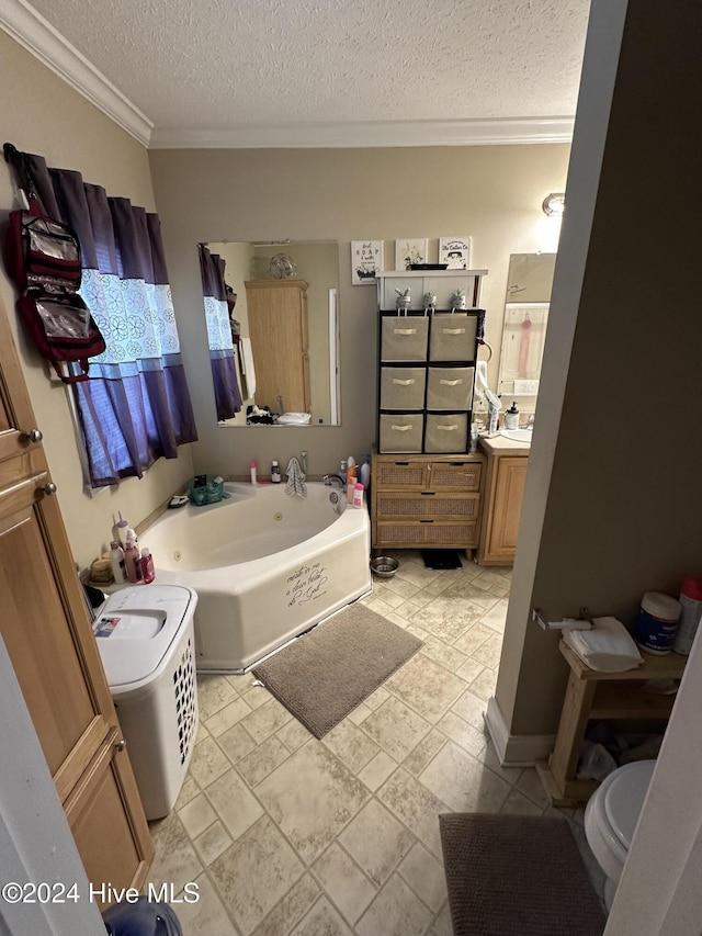 bathroom featuring crown molding, a washtub, vanity, and a textured ceiling