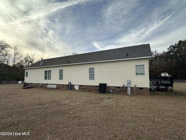 back of house featuring central AC unit