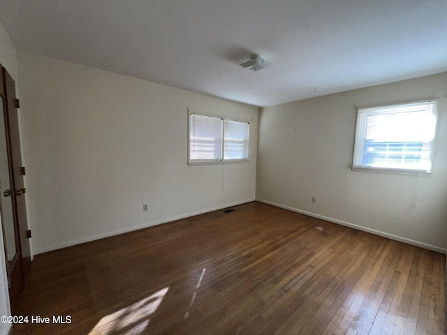 empty room featuring dark hardwood / wood-style flooring