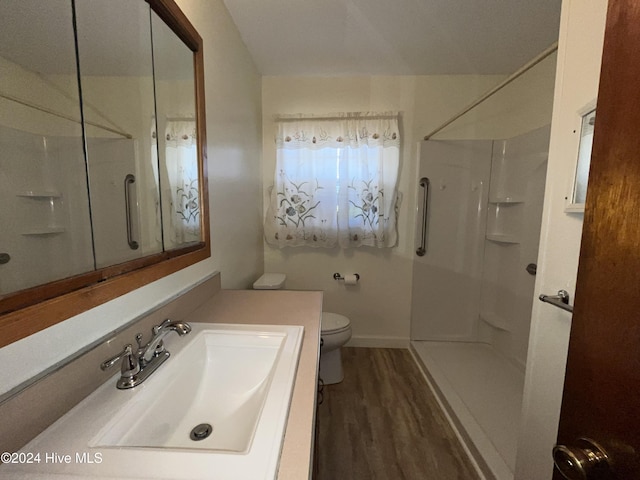 bathroom featuring walk in shower, toilet, sink, and hardwood / wood-style flooring