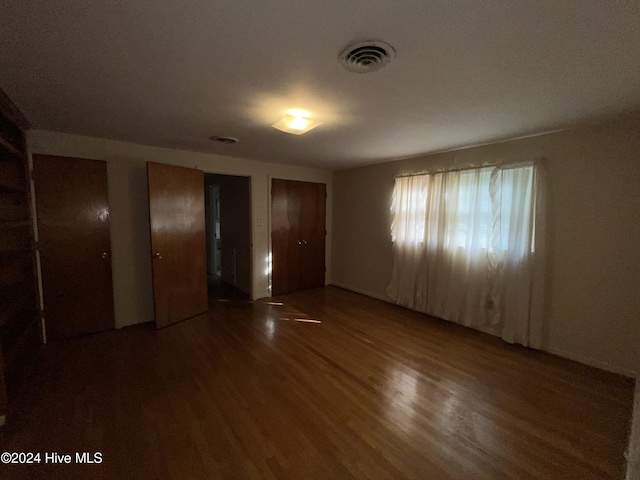 spare room featuring dark hardwood / wood-style flooring