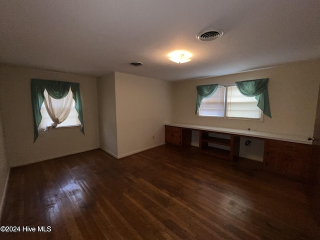 spare room with dark hardwood / wood-style flooring