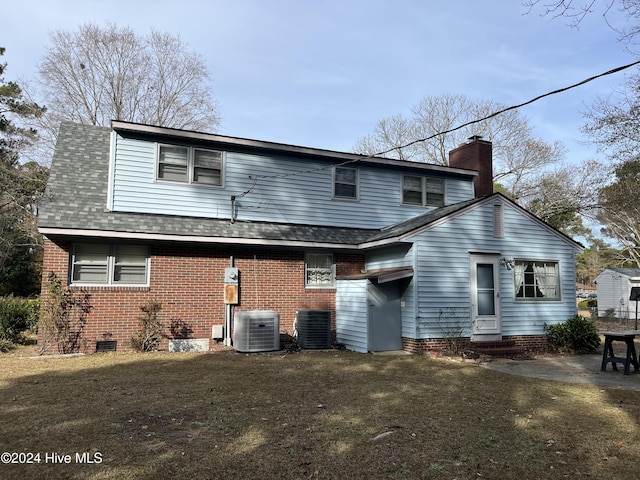 back of property featuring a yard and cooling unit