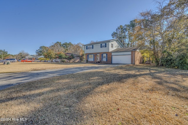 view of front property with a garage and a front lawn