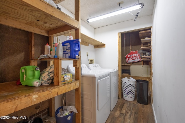 laundry area with washer and dryer, a textured ceiling, and dark hardwood / wood-style floors