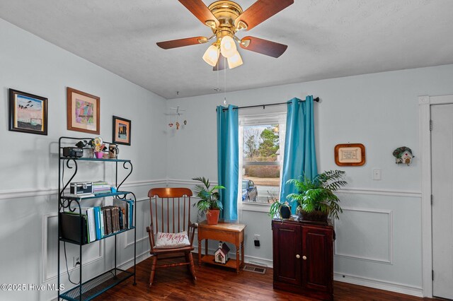 office area with ceiling fan and dark hardwood / wood-style floors