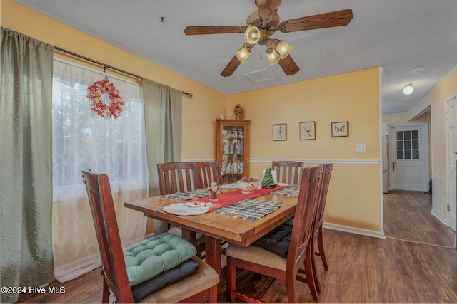 dining area featuring ceiling fan and dark hardwood / wood-style flooring