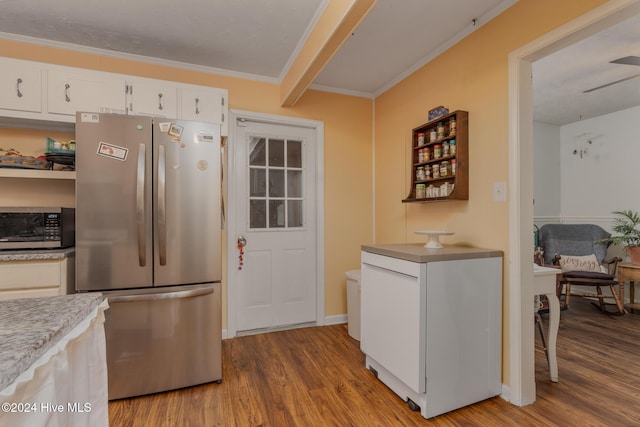 kitchen with light hardwood / wood-style flooring, ornamental molding, appliances with stainless steel finishes, beamed ceiling, and white cabinetry