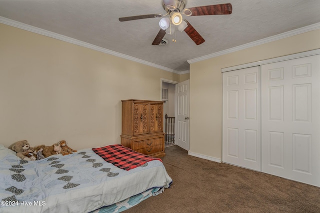 bedroom with carpet, ornamental molding, a textured ceiling, ceiling fan, and a closet